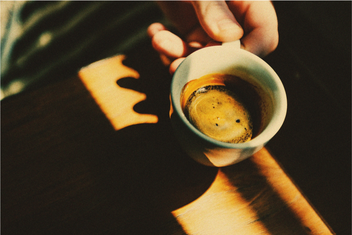 A closeup of an espresso cup with coffee in it
