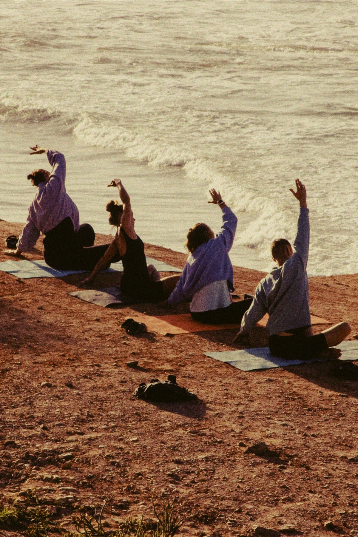 A group of women doing yoga on the beach