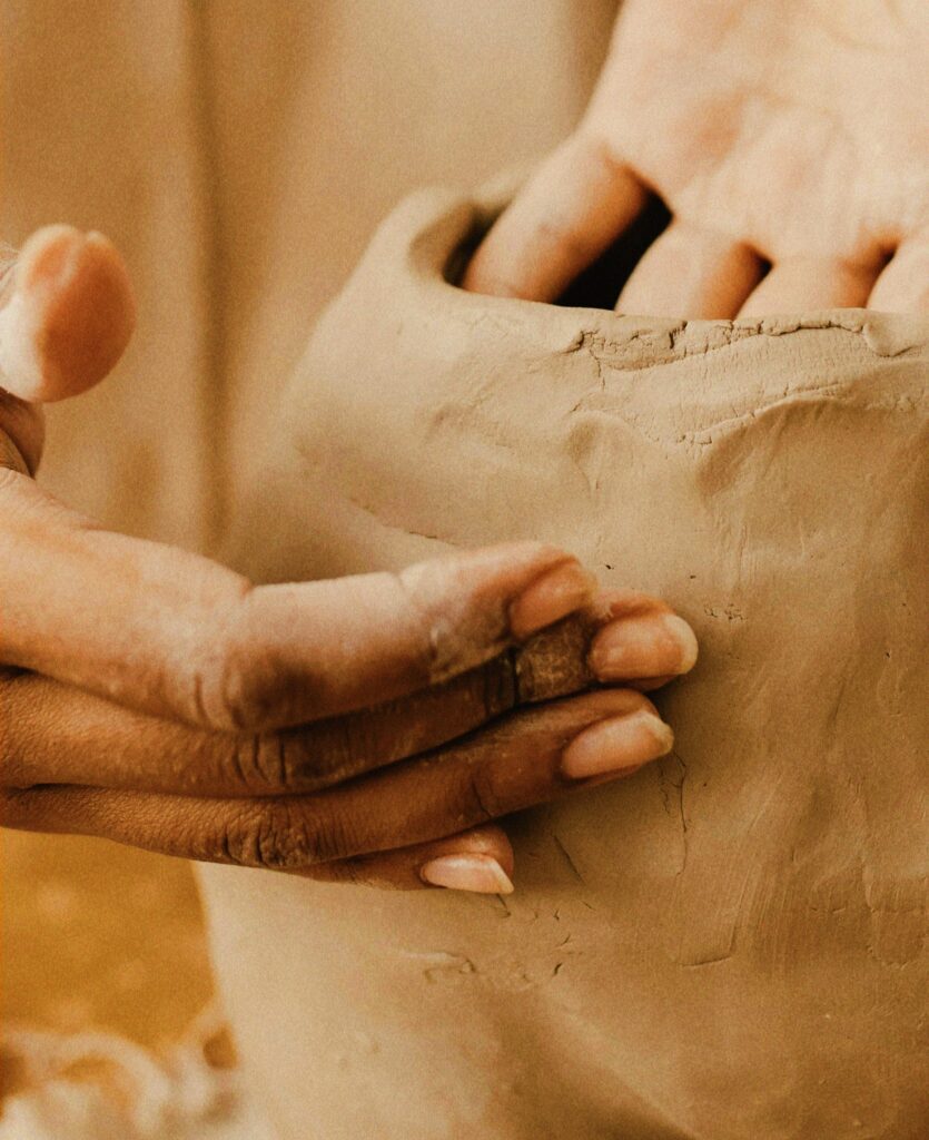 Closeup of hands working with clay